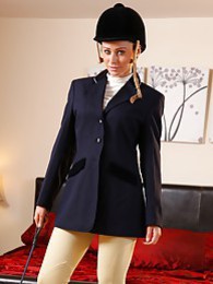 AdsPics presents: Clare R seductifvely removes her riding gear leaving on only opaque hold ups and sheer underwear