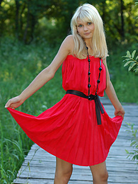 AdsPics presents: Naughty teen appears in her sexy red dress and starts removing it passionately and moving slowly.