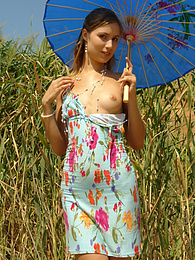 AdsPics presents: Girl in a light dress strolling outdoors, hiding from the sun under the sunshade and stripping